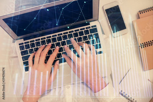 Double exposure of woman hands working on computer and forex chart hologram drawing. Top View. Financial analysis concept. © peshkova