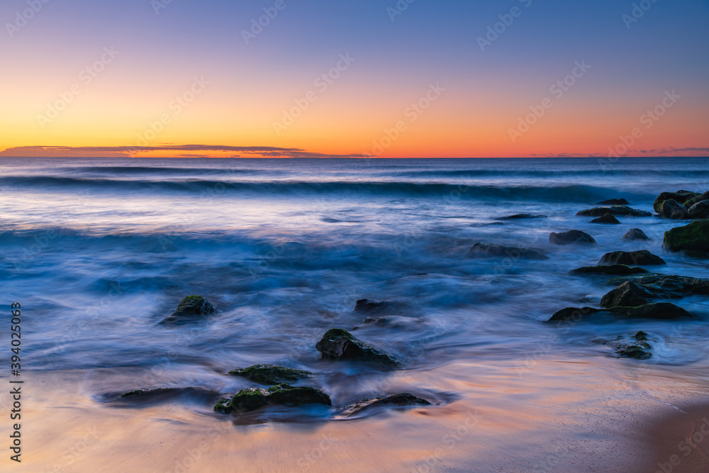Sunrise by the Sea, rocks and soft blue sea