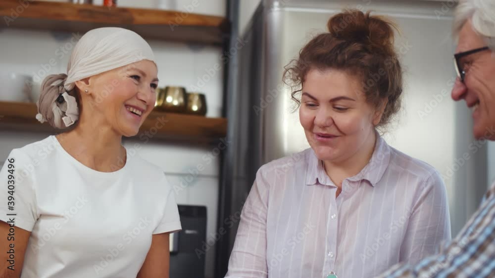 Senior woman after chemo having breakfast with daughter and husband at home Senior woman after chemo having breakfast with daughter and husband at home