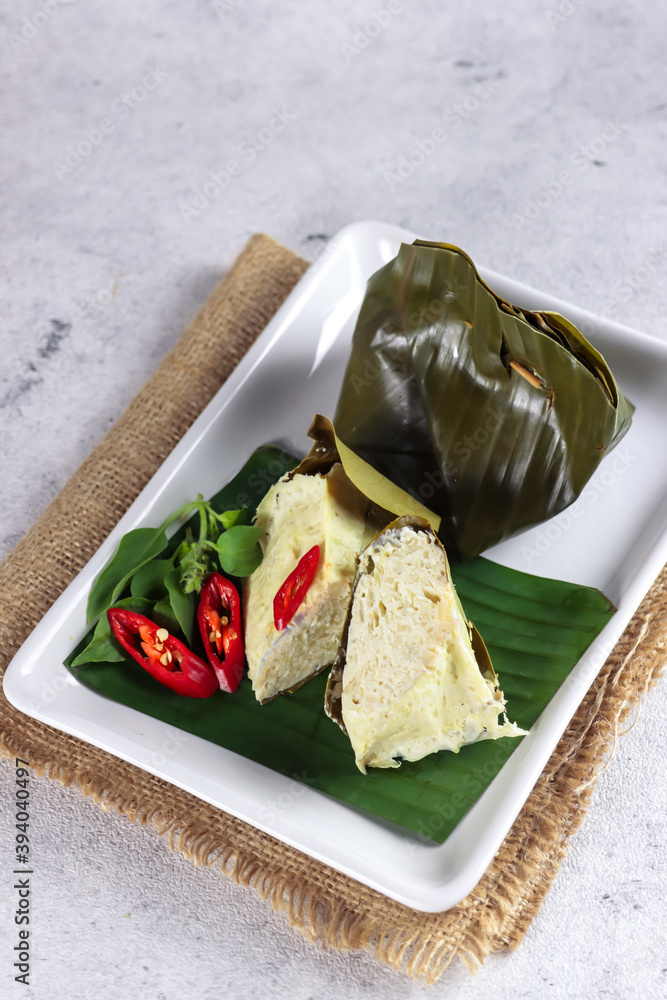 Delicious traditional Indonesian culinary, Tum Ayam or gadon ayam or botok,  steamed minced chicken mix with herb spices and wrapped with banana leaf.  Stock Photo | Adobe Stock