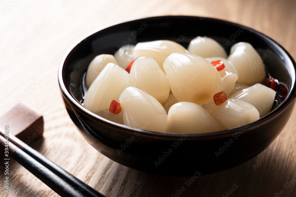 Japanese Rakkyo placed on a wooden background Japanese Rakkyo placed on a wooden background