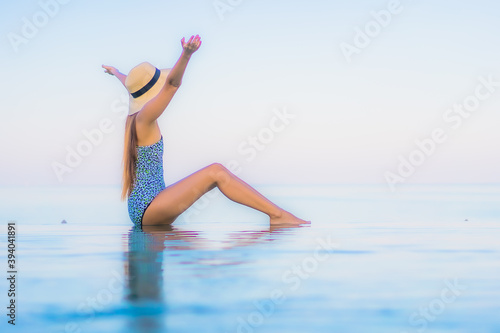 Portrait beautiful young asian woman relax smile leisure around outdoor swimming pool nearly sea