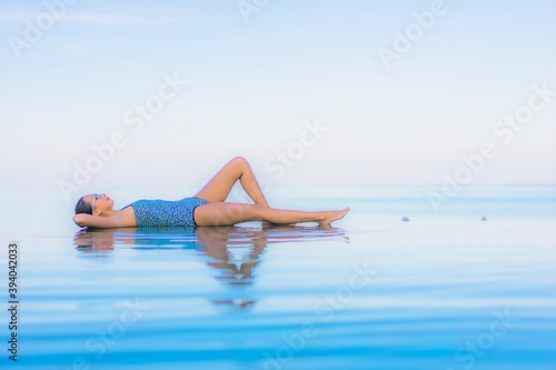 Portrait beautiful young asian woman relax smile leisure around outdoor swimming pool nearly sea
