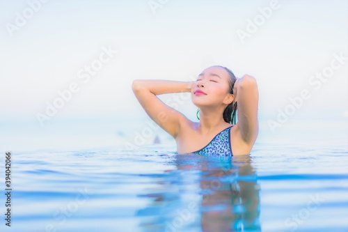 Portrait beautiful young asian woman relax smile leisure around outdoor swimming pool nearly sea © siraphol