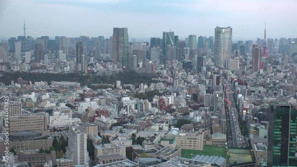 TOKYO, JAPAN : Wide aerial high angle sunset CITYSCAPE of TOKYO. View of buildings around Roppongi from Shibuya. Japanese city life and metropolis concept. Time lapse zoom in shot dusk to night. TOKYO, JAPAN : Wide aerial high angle sunset CITYSCAPE of TOKYO. View of buildings around Roppongi from Shibuya. Japanese city life and metropolis concept. Time lapse zoom in shot dusk to night.