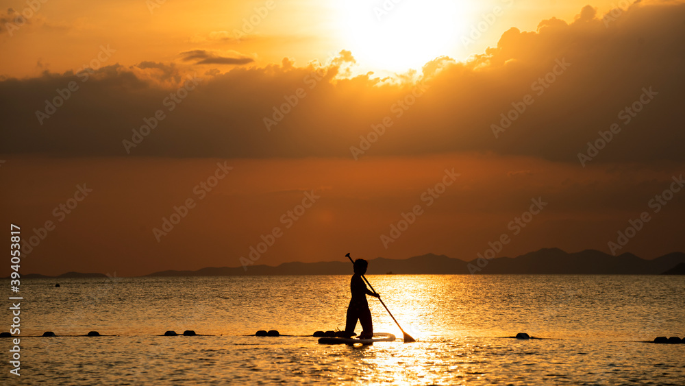 Silhouettes of woman on Surfer board the beach. Surfer female.Beautiful young woman at the beach. water sports. Healthy Active Lifestyle. Surfing. Summer Vacation. Extreme Sport. 