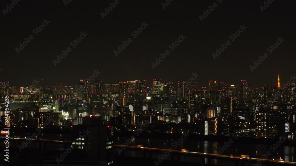 TOKYO, JAPAN : Aerial high angle view of CITYSCAPE of TOKYO at night time. View of busy central downtown area. Japanese urban metropolis and nightlife concept. Wide time lapse zoom out shot. TOKYO, JAPAN : Aerial high angle view of CITYSCAPE of TOKYO at night time. View of busy central downtown area. Japanese urban metropolis and nightlife concept. Wide time lapse zoom out shot.
