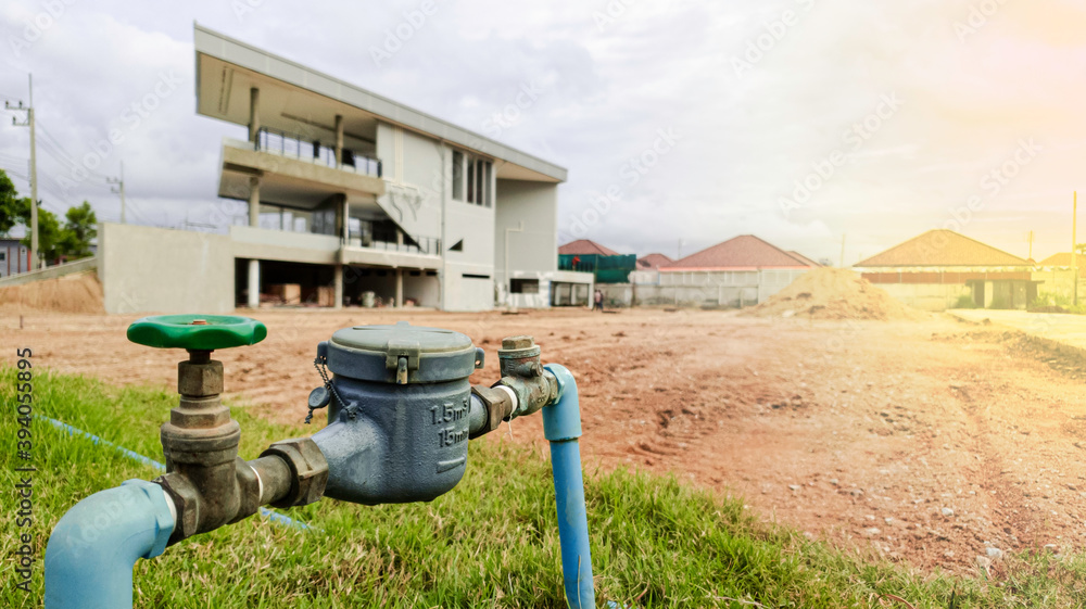 Water meter on concrete with home and green nature background, Water meter for supply consumption mesurement of home plumbing system, water sewer sanitary flow counter valve Water meter on concrete with home and green nature background, Water meter for supply consumption mesurement of home plumbing system, water sewer sanitary flow counter valve