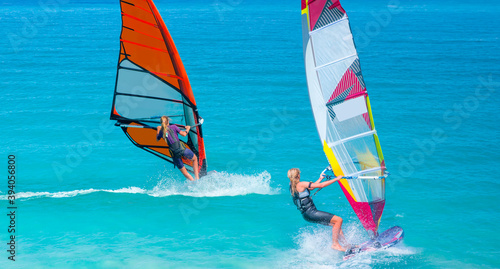 Beautiful cloudy sky with windsurfer surfing the wind on waves in Alacati - Cesme, Turkey