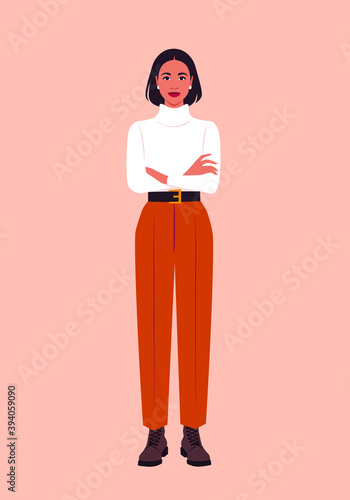 Portrait of a hispanic woman stands full-length with arms crossed. The boss is dressed in casual clothes: a sweater, trousers, boots. Autumn and winter look. Vector flat illustration