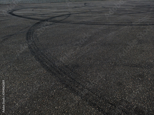 The concept of street racing and drifting on grey asphalt - car tire marks on the asphalt
