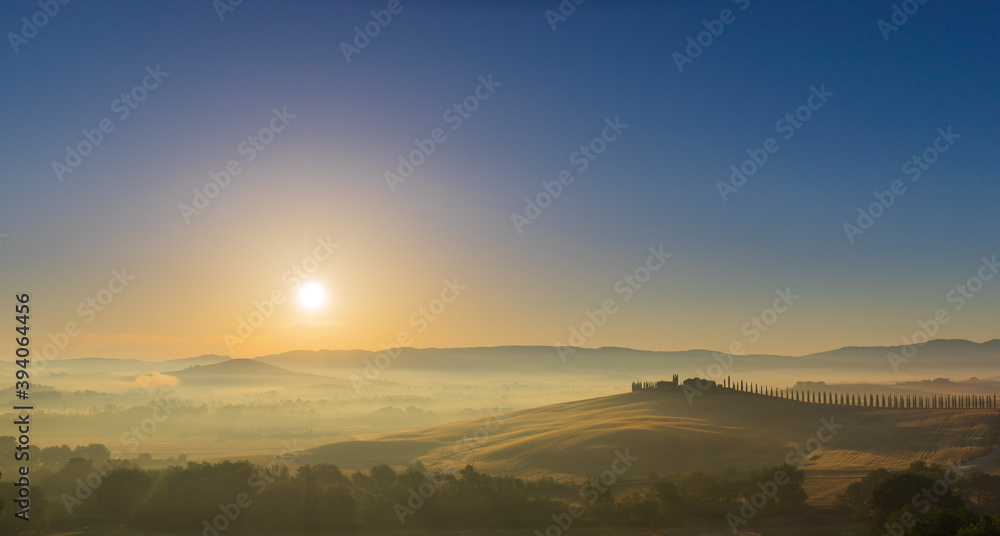 Fototapeta premium The rolling hills and green fields at sunrise, Tuscany, Italy