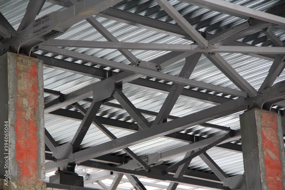 An old steel metal farm. structure of metal structure of frame-type industrial building. Lightweight metal frame construction. An old steel metal farm. structure of metal structure of frame-type industrial building. Lightweight metal frame construction.