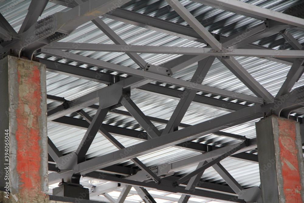 An old steel metal farm. structure of metal structure of frame-type industrial building. Lightweight metal frame construction.