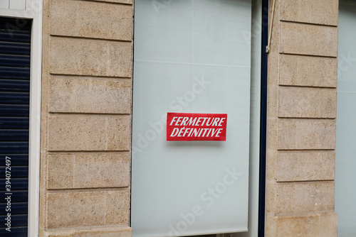 Fototapeta Naklejka Na Ścianę i Meble -  windows shop panel fermeture definitive french text means final closure on panel sign written on store facade in france