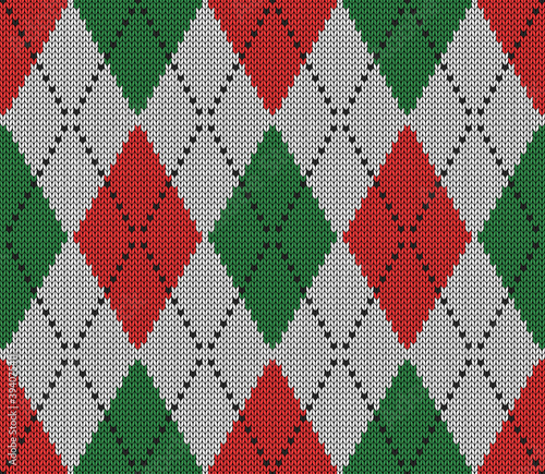 Knitted argyle Christmas and new year pattern. Wool knitinng. Scottish plaid in red, white and green rhombuses. Traditional background of diamonds. Seamless fabric texture. Vector illustration