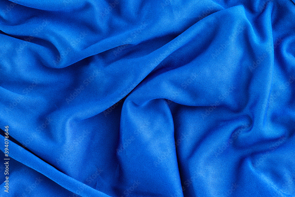Blue folded fabric texture background Blue folded fabric texture background
