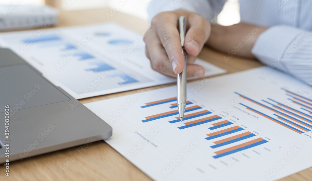 Business men analyze graphs of financial accounts in private office. Business men analyze graphs of financial accounts in private office.