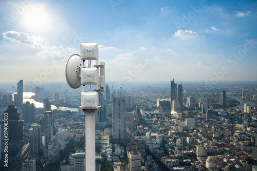 Telecommunication tower with 5G cellular network antenna on city background