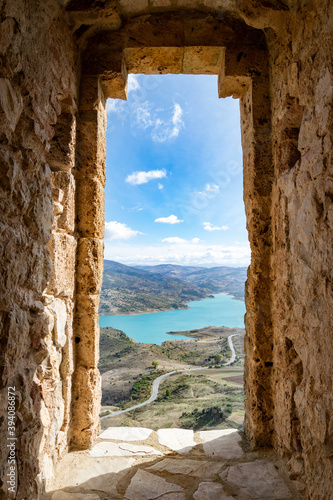 a view through a stone window from the castle ruins of Zahara de la Sierra 