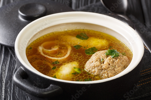 Rindsuppe Traditional Soup From Vienna, Austria close-up in a saucepan on the table. horizontal