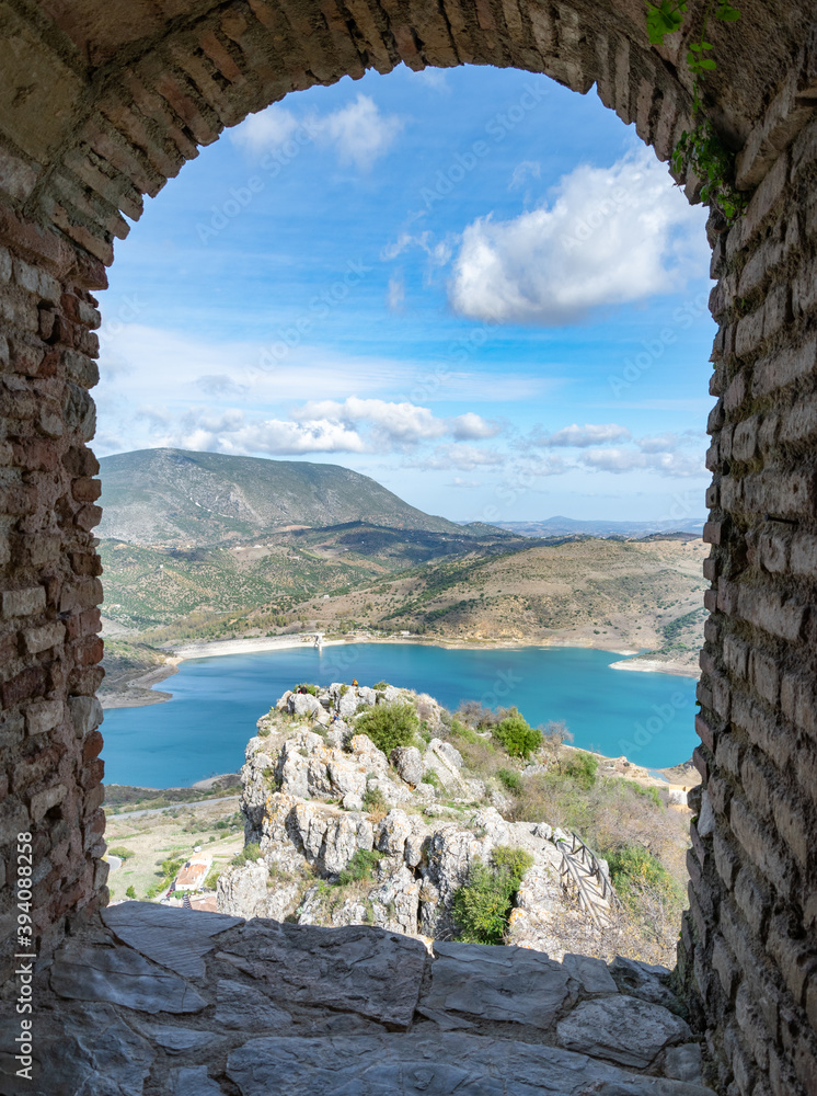 a view through a stone window from the ruins at Zahara de la Sierra