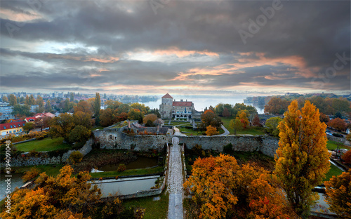 Castle of Tata city in Hungary. Amazing water fort next to Old lake. Built in 13th century. Beautiful dramatic sunrise view.