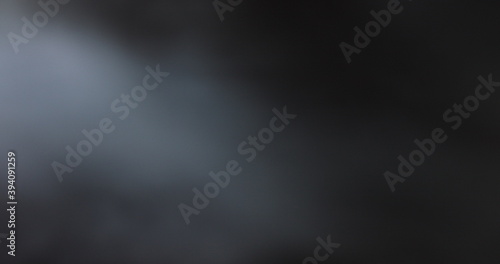 Atmospheric smoke 4K Fog effect. Smoke in slow motion on black background. White smoke slowly floating through space against black background photo