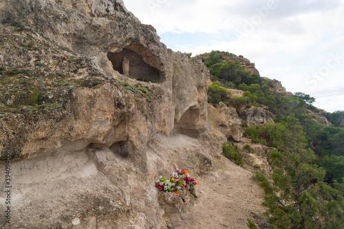 Small sanctuary with offerings to the Virgen del Pilar in the middle of the nature on the ascent to Cabezo del Sillon in Maria de Huerva, Zaragoza, Spain photo