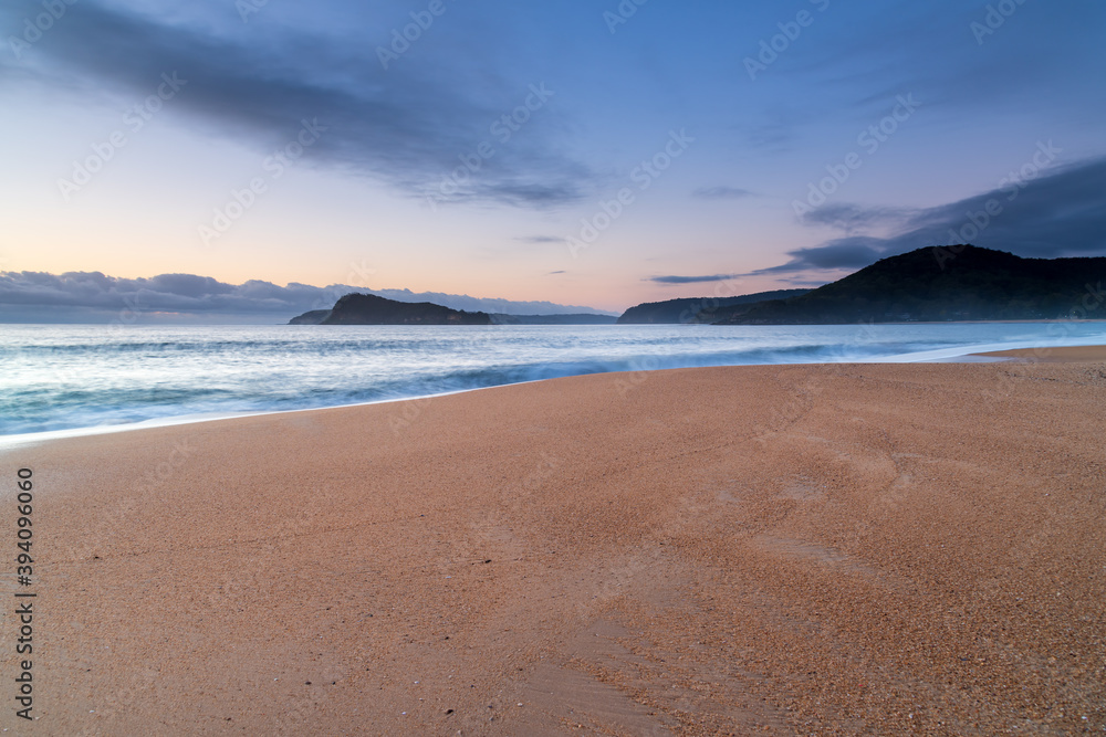 Sunrise by the sea with cloud bank on the horizon