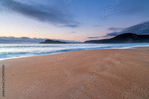 Sunrise by the sea with cloud bank on the horizon