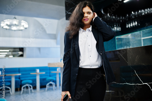 Gorgeous indian woman wear formal posing at cafe near bar counter.