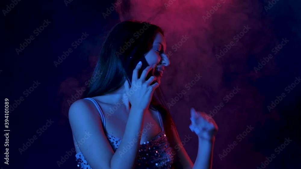 Portrait of charming young woman talking on his smartphone smiles and rejoices. Close up. Slow motion. Portrait of charming young woman talking on his smartphone smiles and rejoices. Close up. Slow motion.