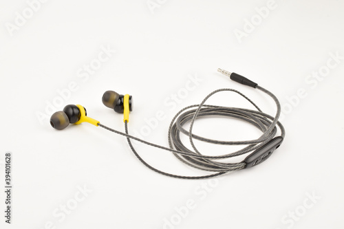 Folded earphone with mic isolated on white background 