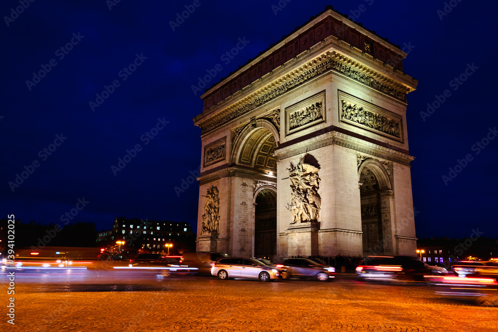 View of famous Arc de Triomphe in Charles de Gaulle square at night in Paris, France