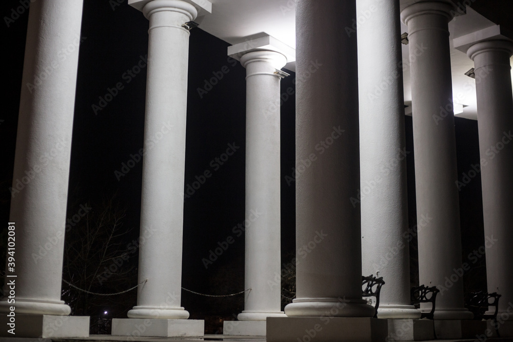 Illuminated columns with white light. Many columns on the house Illuminated columns with white light. Many columns on the house