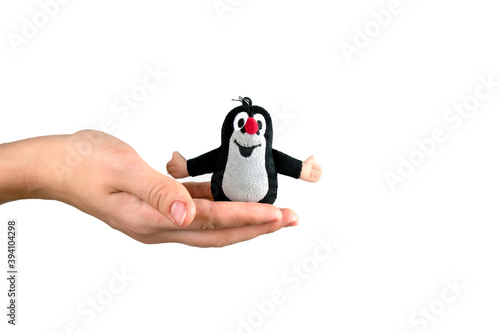 Czech Republic, Prague-2020 November: a Small plush toy of a Czech mole on a white isolated background. The girl is holding a small toy Czech mole.