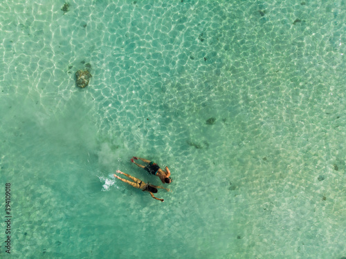 couple snorkeling in turquoise water