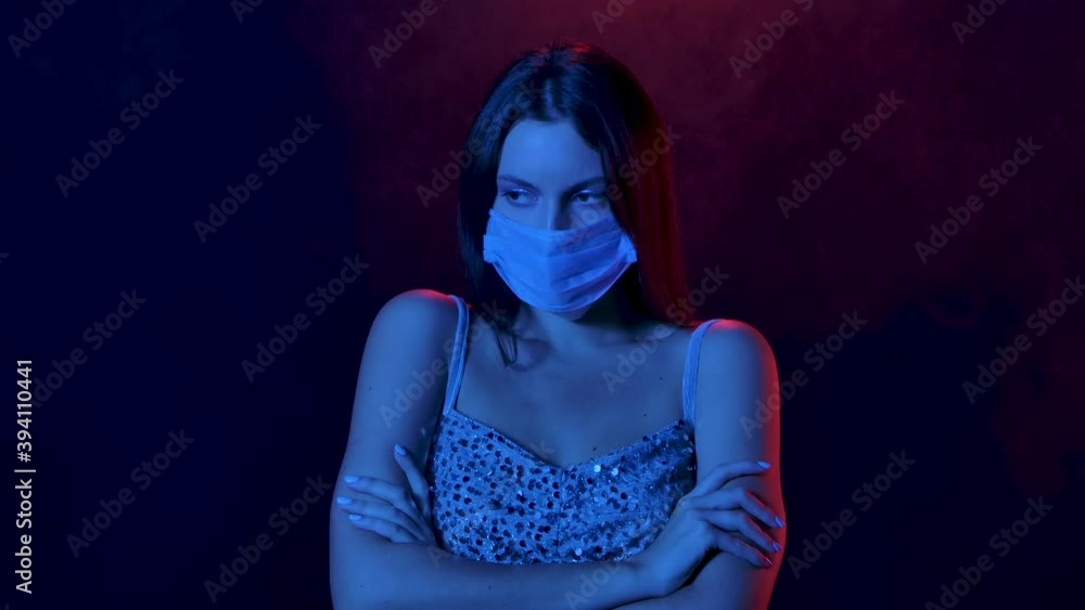 Portrait of charming young woman in a medical mask offended and upset. Close up. Slow motion. Portrait of charming young woman in a medical mask offended and upset. Close up. Slow motion.