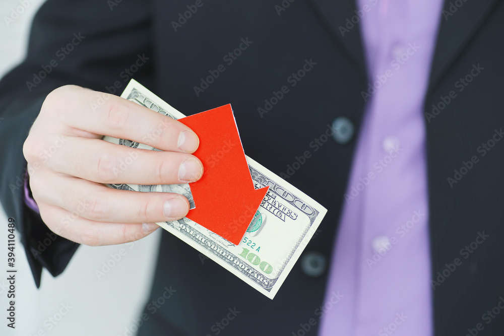 Financial crisis. Concept. Money bills in hand. Arrow symbol of the fall of the national currency. The change in the exchange rate between the Russian ruble and the US dollar. Financial crisis. Concept. Money bills in hand. Arrow symbol of the fall of the national currency. The change in the exchange rate between the Russian ruble and the US dollar.