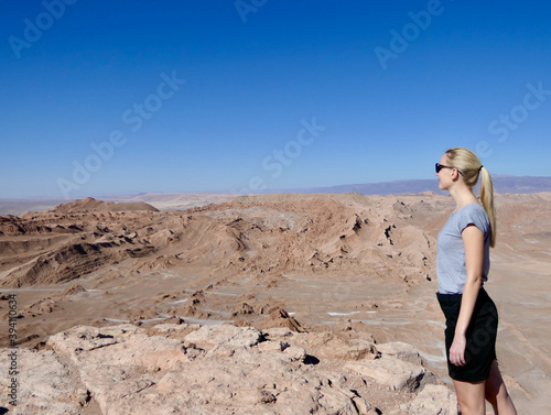 Blond woman on cliff in Atacama salt desert landscape, Chile © HWL Photos