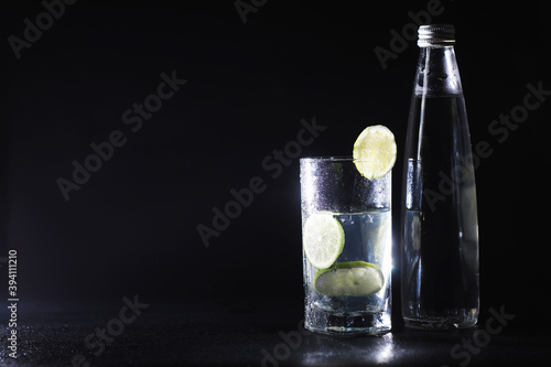 Lime water. Drinking water with fresh lime. Mineral water. Healthy, mineral-rich, refreshing water with lime.