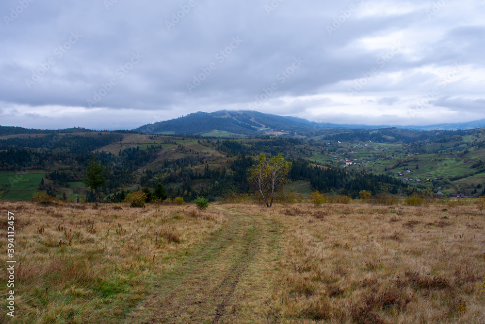 Mountain country road, beautiful cloudy sky. Landscape.