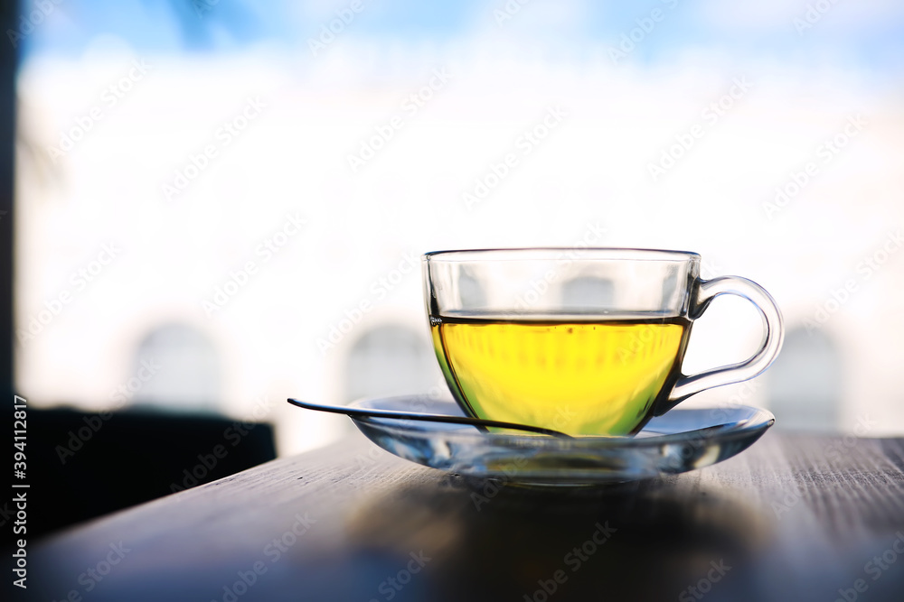 Hot steaming green tea in a cup on a rustic background Hot steaming green tea in a cup on a rustic background
