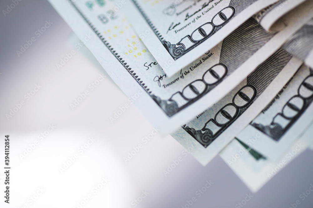 Fototapeta premium Group of money stack of 100 US dollars banknotes a lot of the background texture. Cash money in a large pile as a finance background.