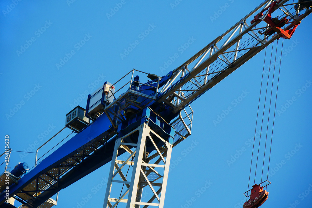 Crane. Tower crane against blue sky. Self-erecting crane.