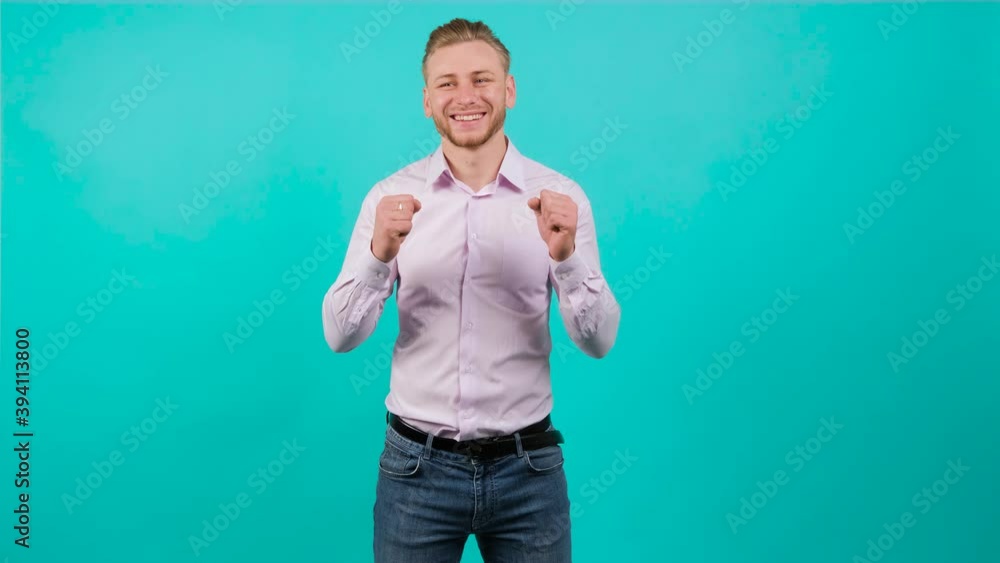 Yes winner gesture. Amazed happy man shocked. Handsome guy surprised to camera over turquoise background. Yes winner gesture. Amazed happy man shocked. Handsome guy surprised to camera over turquoise background.
