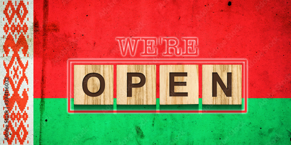 We are open. The inscription on wooden blocks against the background of the flag of Belarus. Business.