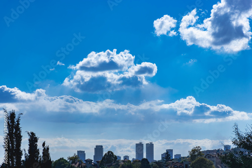 From distance skyscrapers and cloudy birght sky