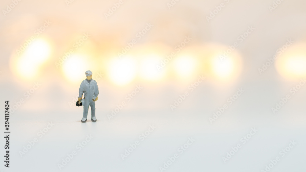Miniature people : Close up engineer with paper airplane isolated on white background 
